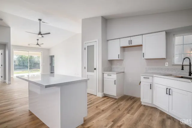 a kitchen with stainless steel appliances a sink stove and cabinets