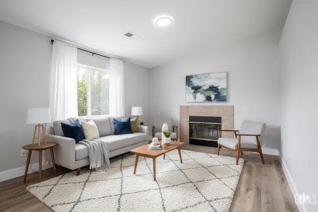 a living room with furniture and a fireplace
