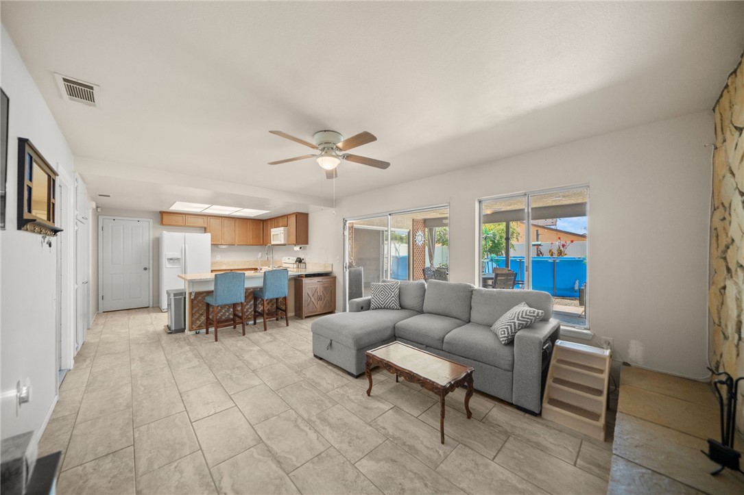 27879 Foxfire Street Menifee, CA 92586 - Photo 19 of 36 a living room with furniture and a chandelier