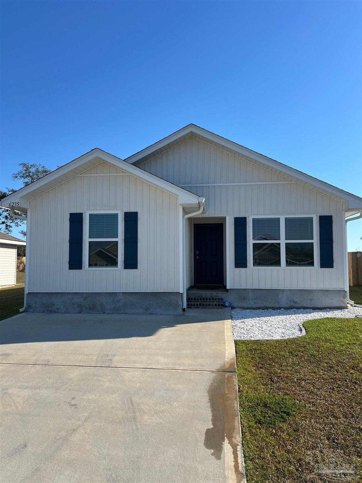 6235 June Bug Drive Milton, FL 32583 - Photo 1 of 20 a front view of a house with a garden