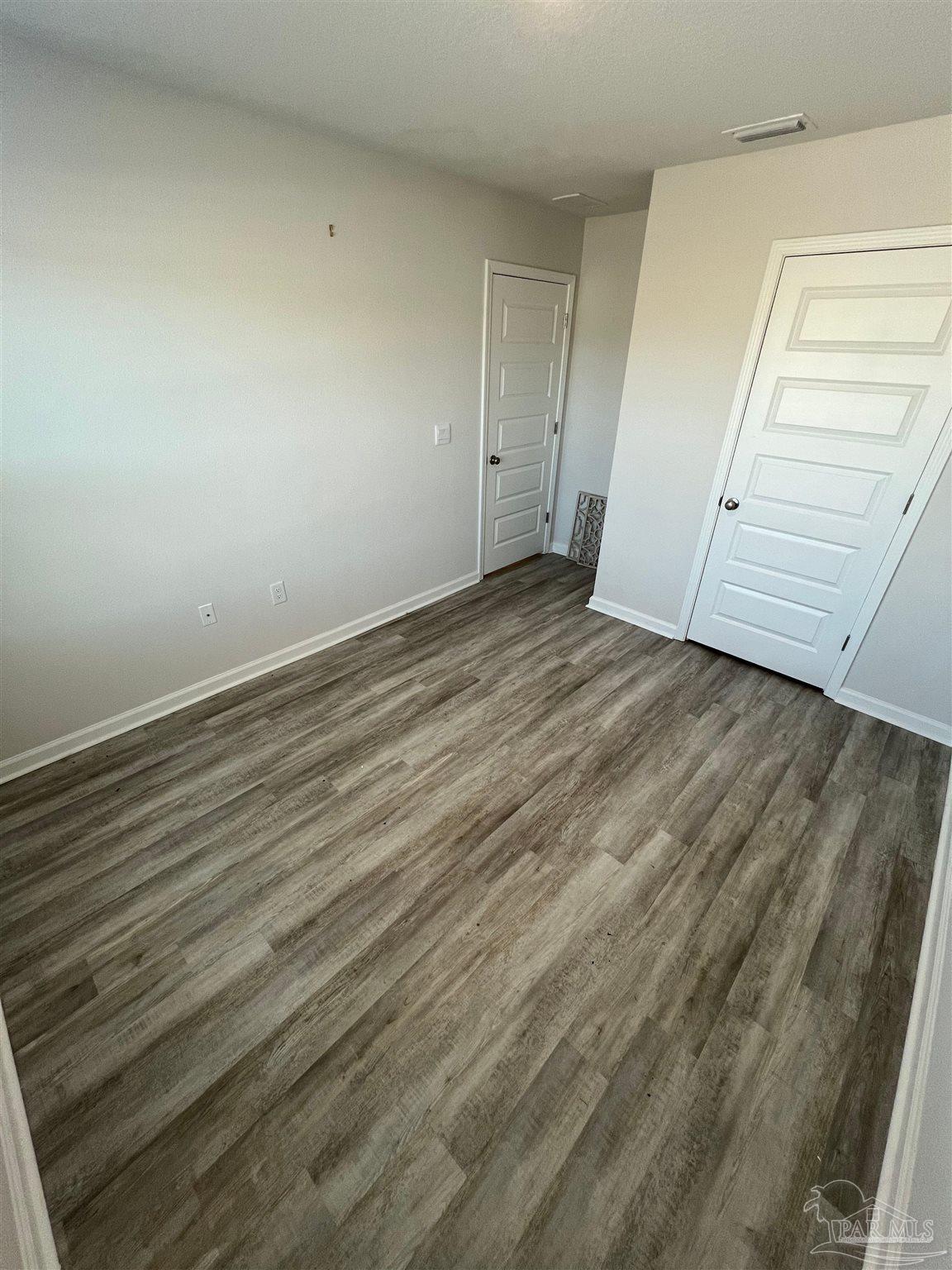 6235 June Bug Drive Milton, FL 32583 - Photo 11 of 20 wooden floor in an empty room