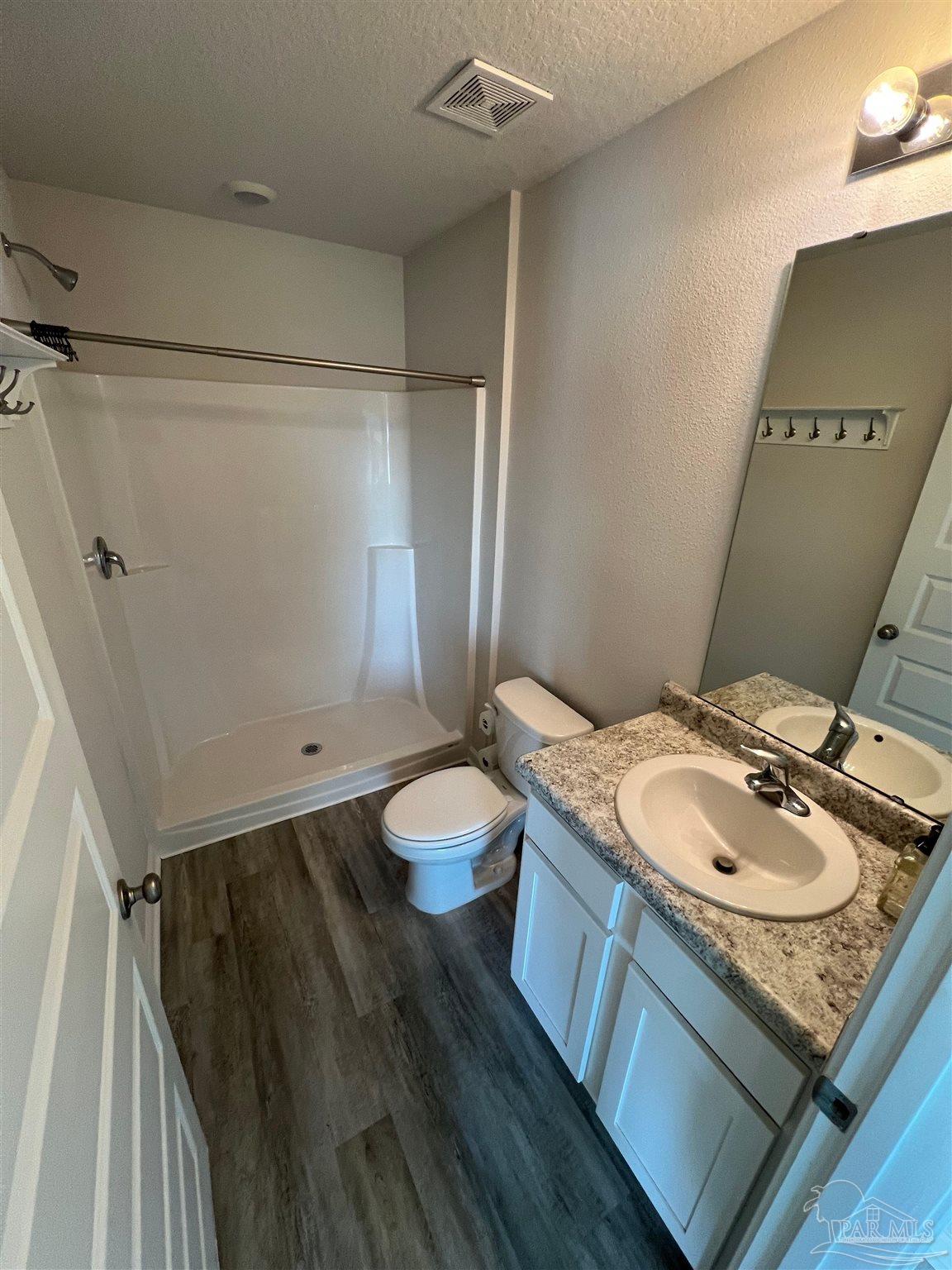 6235 June Bug Drive Milton, FL 32583 - Photo 12 of 20 a bathroom with a granite countertop sink toilet and shower