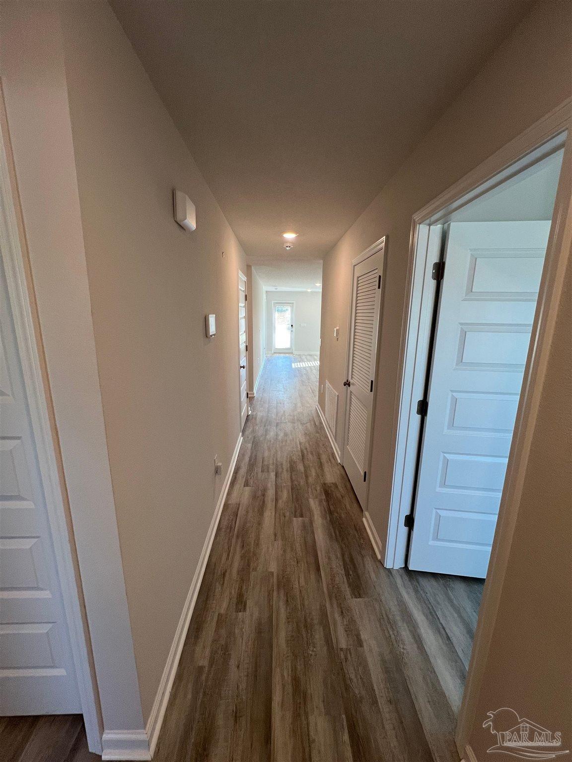 6235 June Bug Drive Milton, FL 32583 - Photo 4 of 20 a view of a hallway with wooden floor and staircase