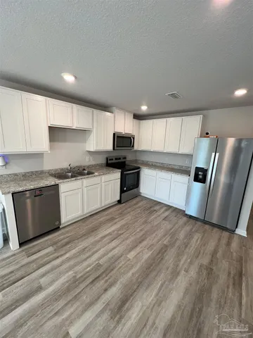 a view of a room with wooden floor