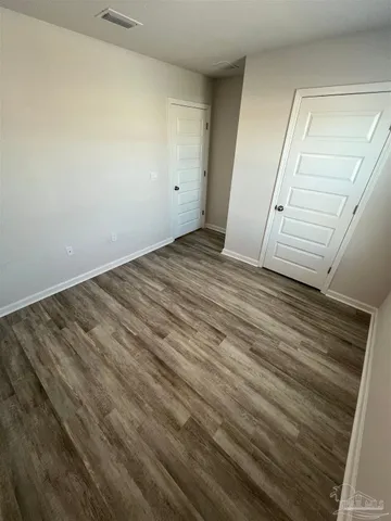 an empty room with wooden floor