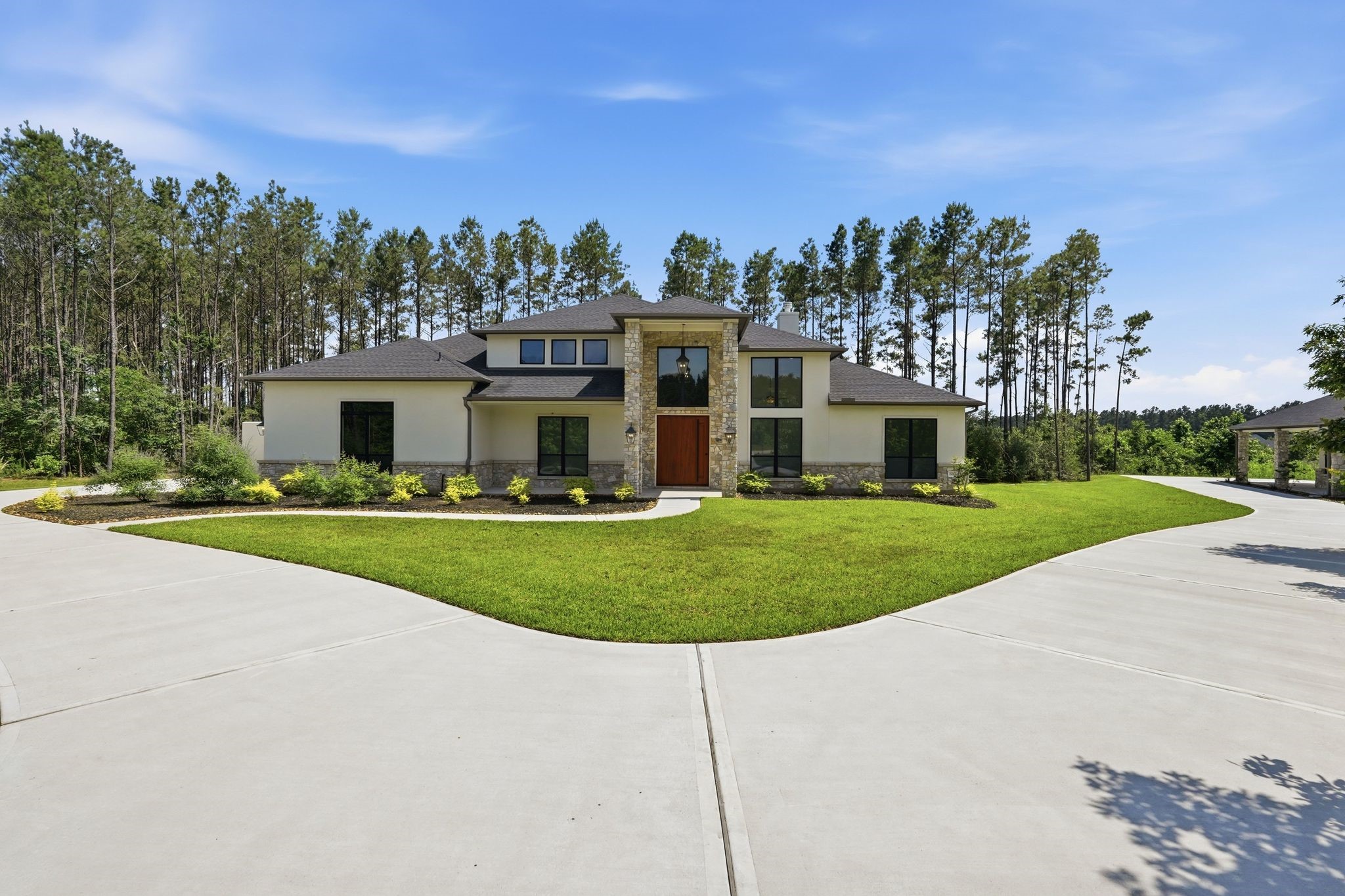 16081 Forest Mill Road Willis, TX 77378 - Photo 2 of 37 Stunning custom estate nestled on acreage in Republic Grand Ranch. The stone and stucco exterior create a grand first impression.