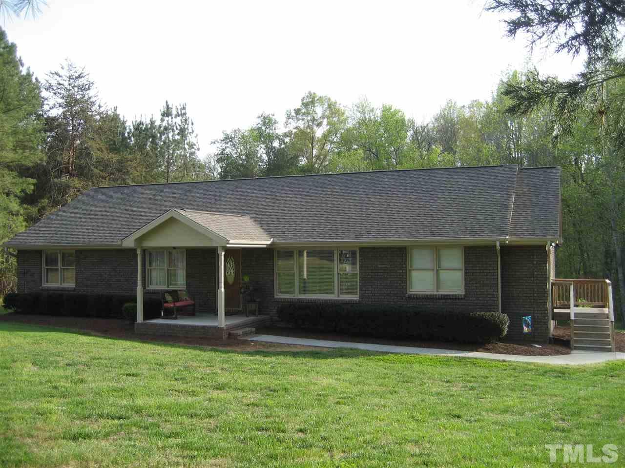 9740 South Lowell Road Bahama, NC 27503 - Photo 1 of 17 a front view of a house with a garden