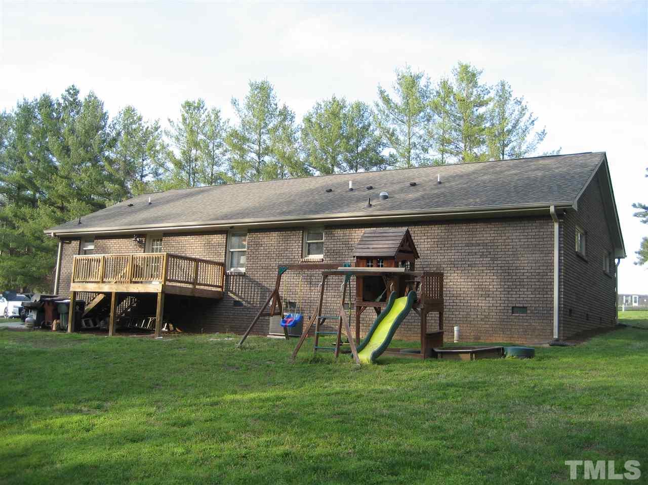 9740 South Lowell Road Bahama, NC 27503 - Photo 4 of 17 a view of a house with a yard and potted plants