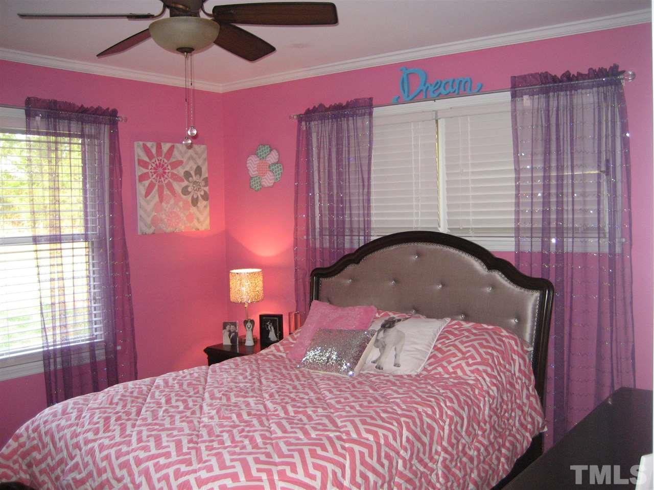 9740 South Lowell Road Bahama, NC 27503 - Photo 10 of 17 a bedroom with a bed and a chandelier