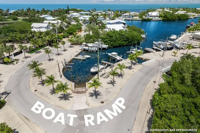 an aerial view of a house with a yard and lake view
