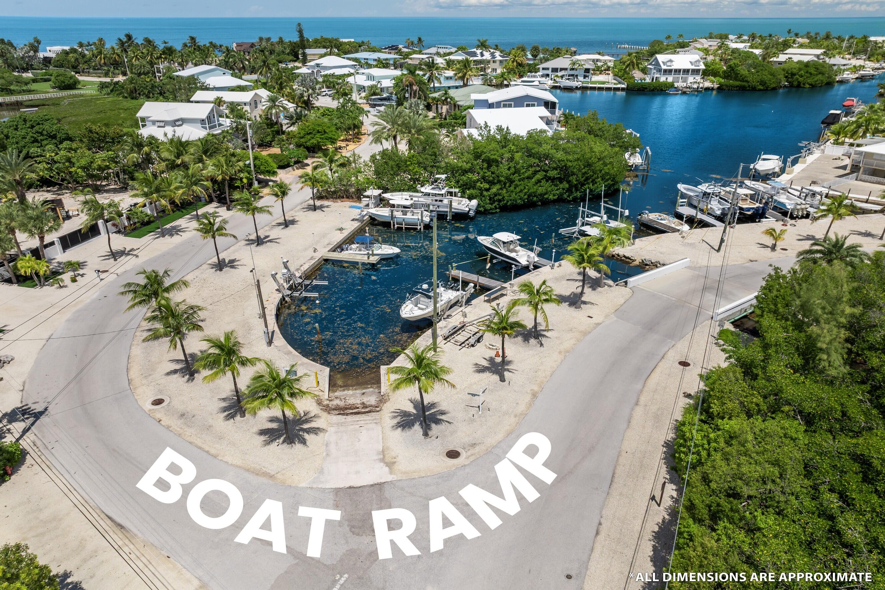 98 Stirrup Key Boulevard Marathon, FL 33050 - Photo 3 of 15 an aerial view of a house with a yard and lake view