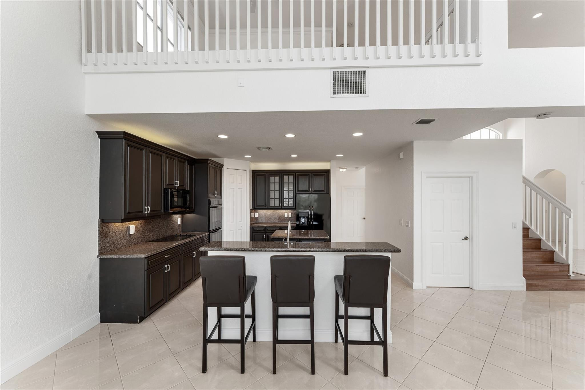 5318 Southwest 195th Terrace Miramar, FL 33029 - Photo 14 of 67 a kitchen with kitchen island cabinets and refrigerator