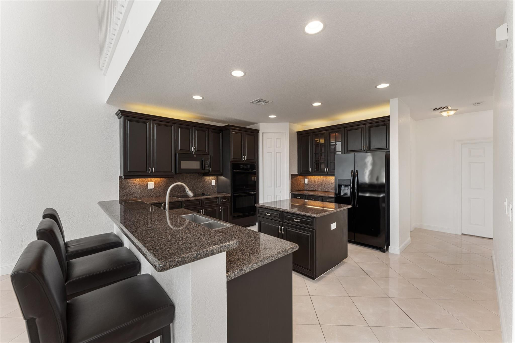 5318 Southwest 195th Terrace Miramar, FL 33029 - Photo 15 of 67 a kitchen with stainless steel appliances granite countertop a sink and stove