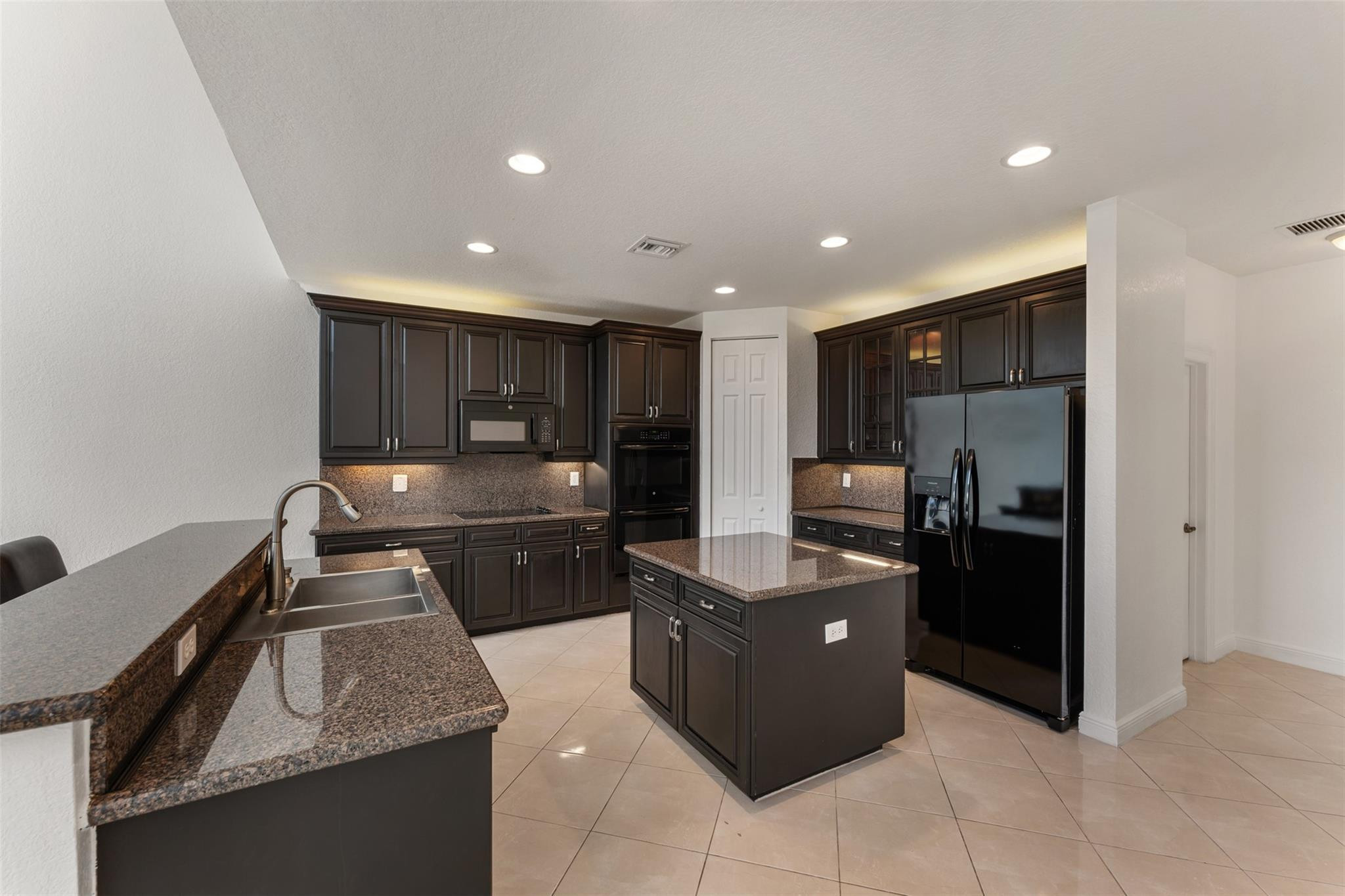 5318 Southwest 195th Terrace Miramar, FL 33029 - Photo 16 of 67 a kitchen with stainless steel appliances granite countertop a sink and stove