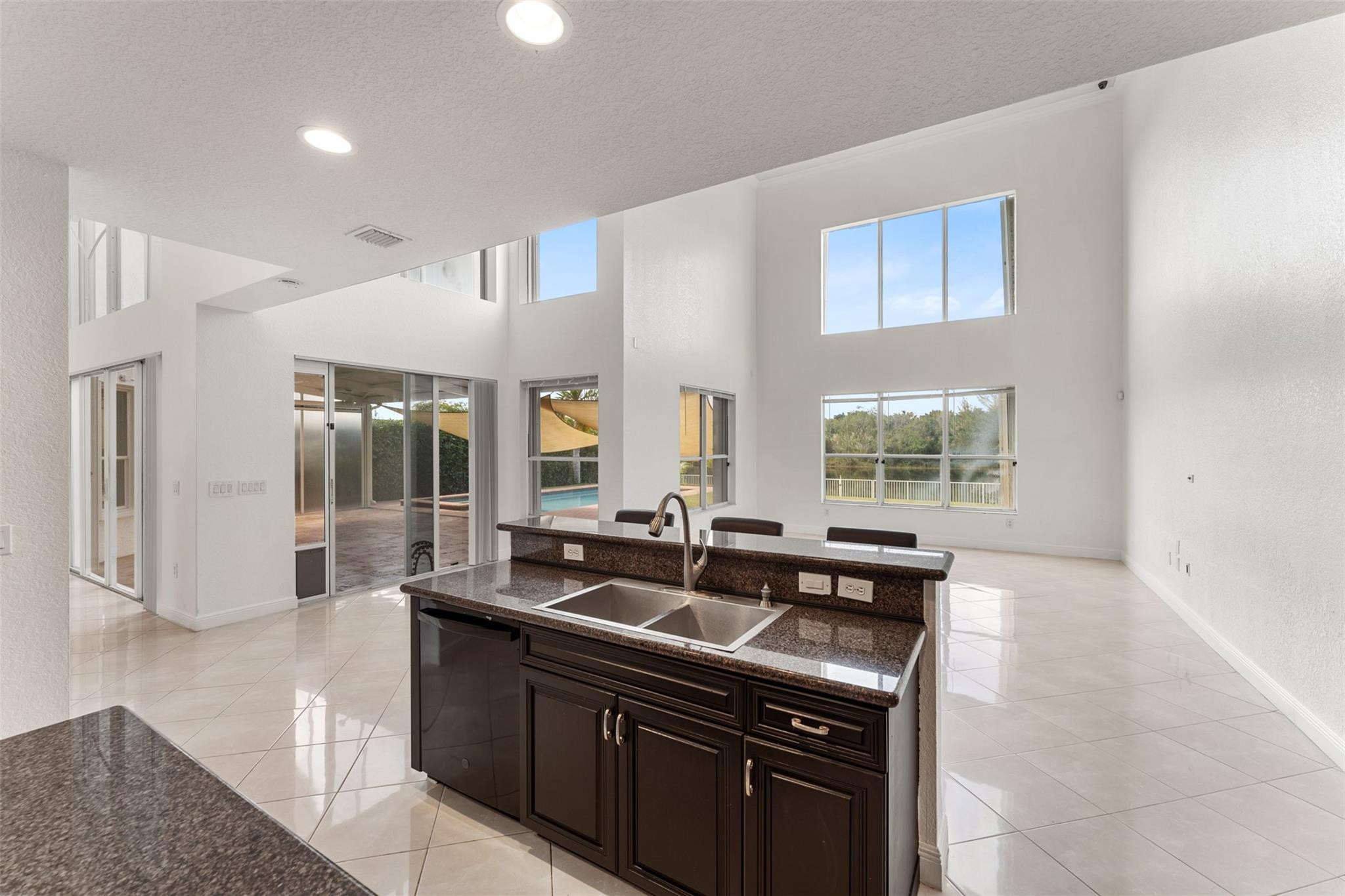5318 Southwest 195th Terrace Miramar, FL 33029 - Photo 18 of 67 a kitchen with granite countertop a sink and a stove
