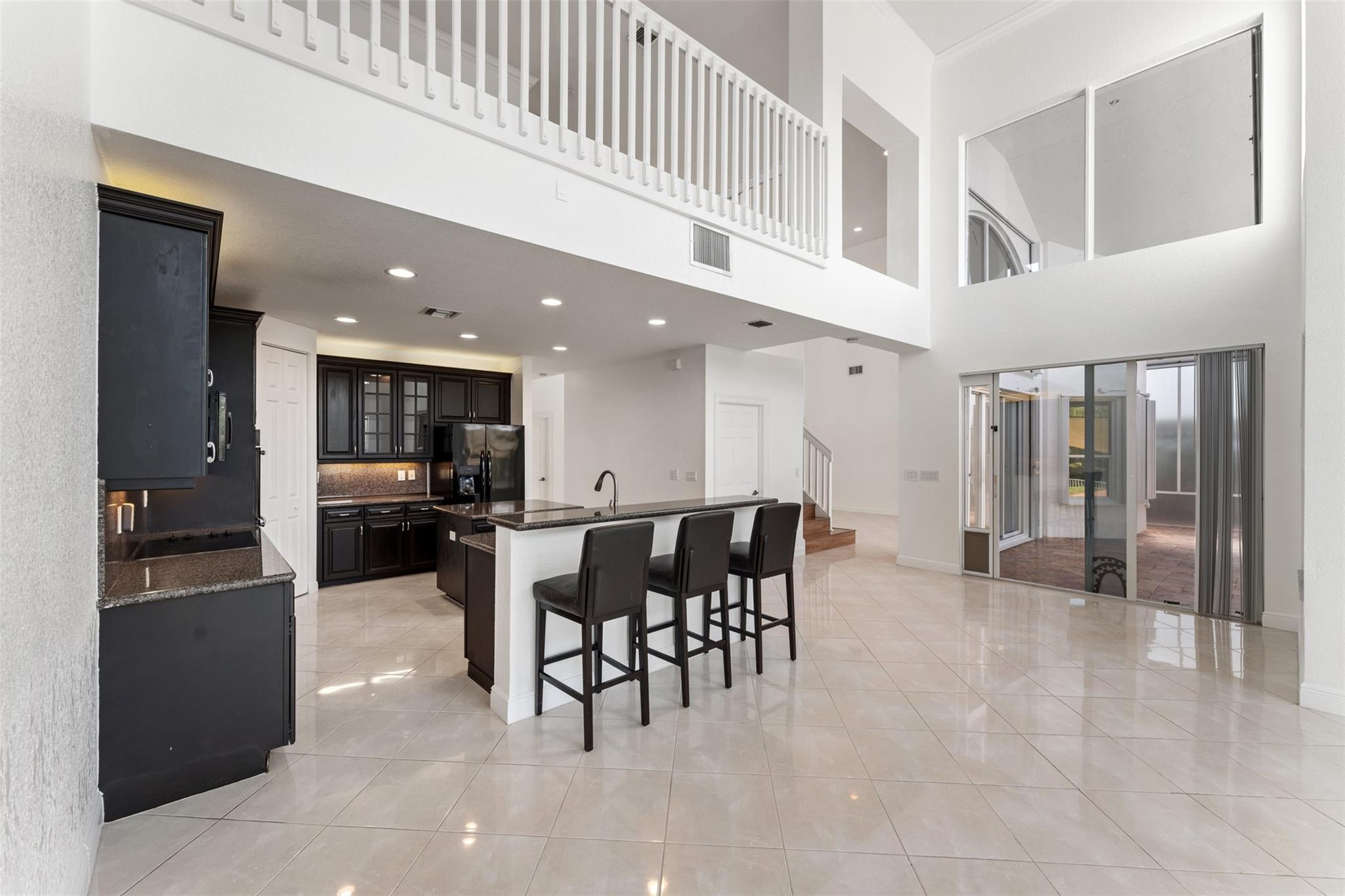 5318 Southwest 195th Terrace Miramar, FL 33029 - Photo 19 of 67 a kitchen with stainless steel appliances kitchen island granite top and refrigerator