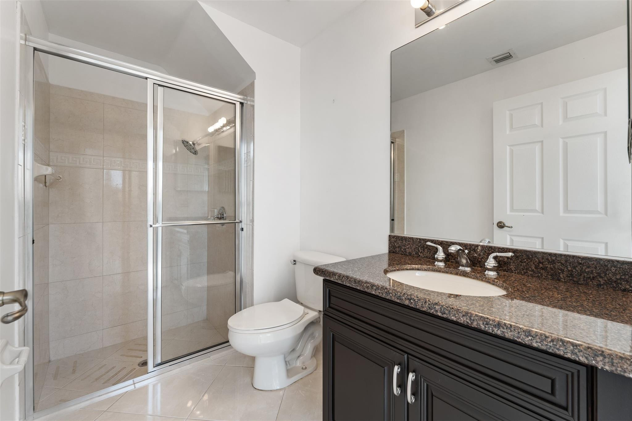 5318 Southwest 195th Terrace Miramar, FL 33029 - Photo 20 of 67 a bathroom with a granite countertop sink toilet and shower