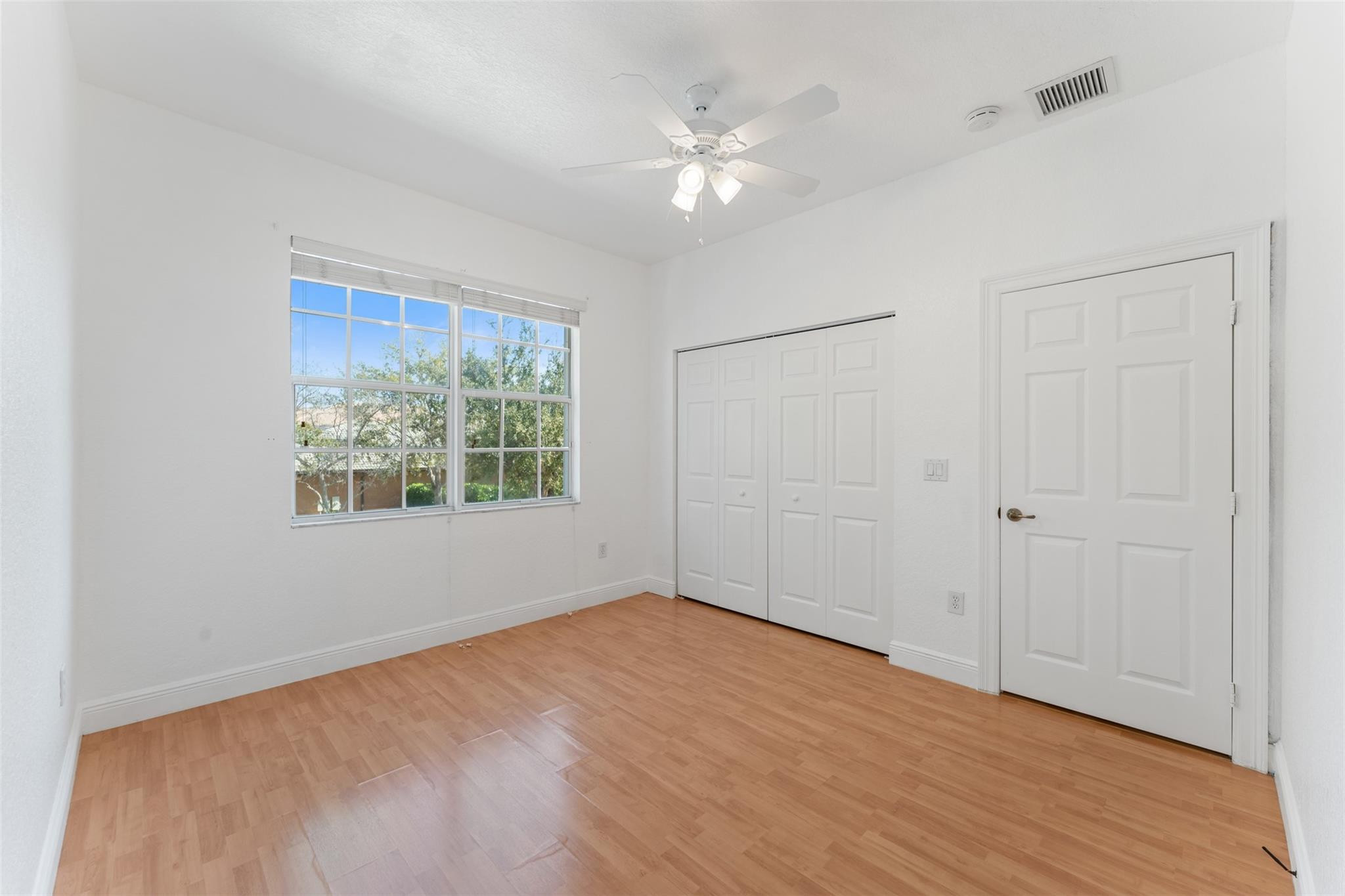 5318 Southwest 195th Terrace Miramar, FL 33029 - Photo 49 of 67 a view of an empty room with a window and wooden floor