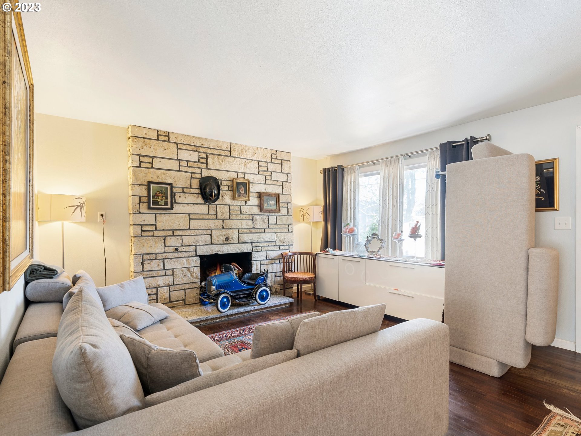 17680 Southwest Alexander Street Beaverton, OR 97003 - Photo 11 of 38 a living room with furniture and a fireplace