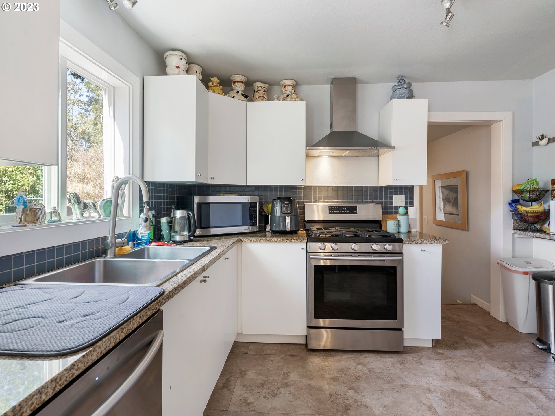 17680 Southwest Alexander Street Beaverton, OR 97003 - Photo 17 of 38 a kitchen with stainless steel appliances granite countertop a stove and a sink