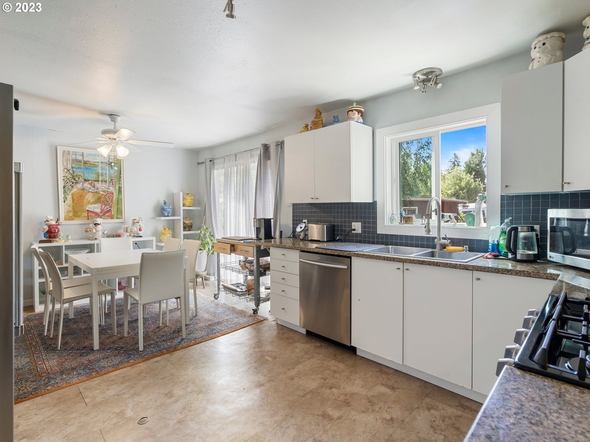 17680 Southwest Alexander Street Beaverton, OR 97003 - Photo 18 of 38 a large kitchen with lots of counter top space and stainless steel appliances