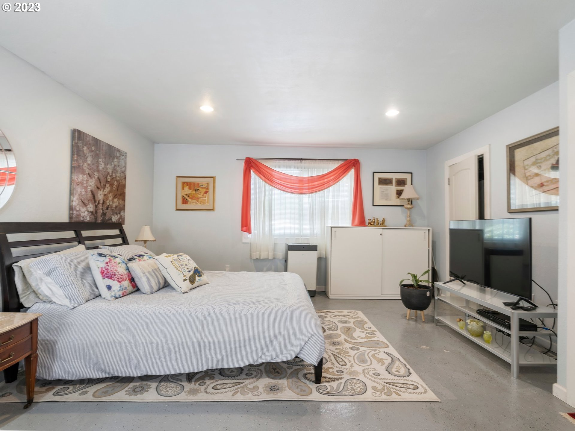 17680 Southwest Alexander Street Beaverton, OR 97003 - Photo 20 of 38 a bedroom with a bed and a flat screen tv