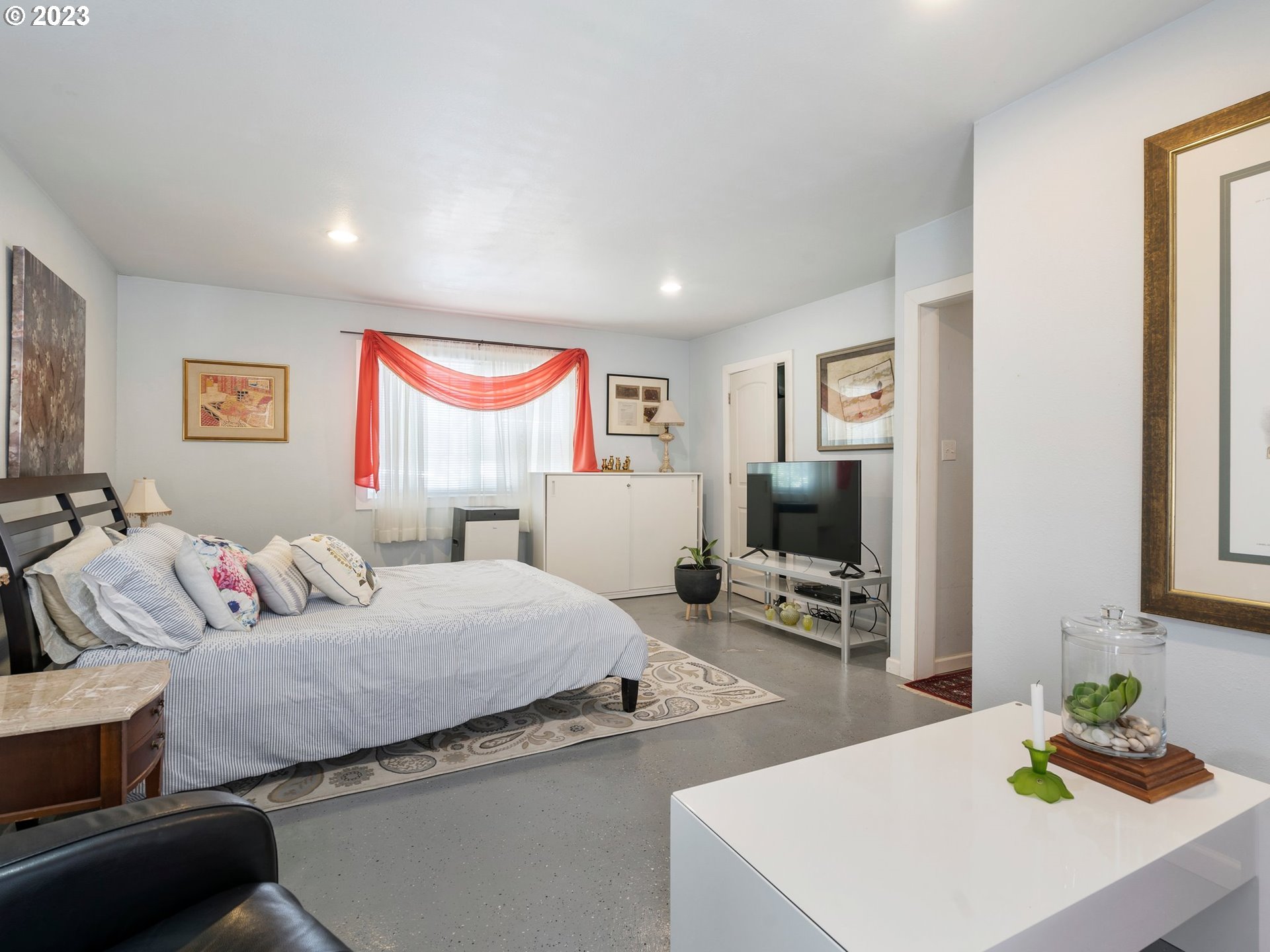 17680 Southwest Alexander Street Beaverton, OR 97003 - Photo 21 of 38 a bedroom with a bed and a flat tv screen