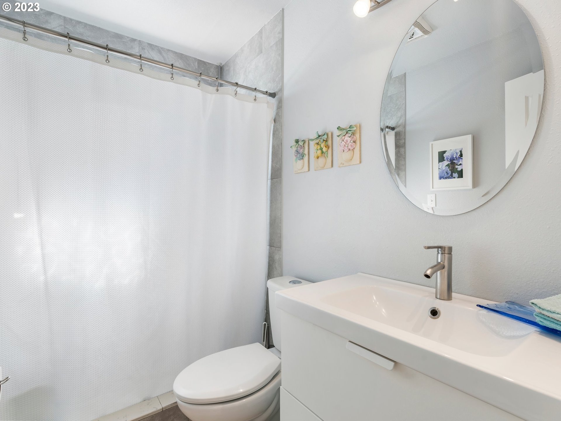 17680 Southwest Alexander Street Beaverton, OR 97003 - Photo 28 of 38 a white toilet sitting next to a bathroom sink