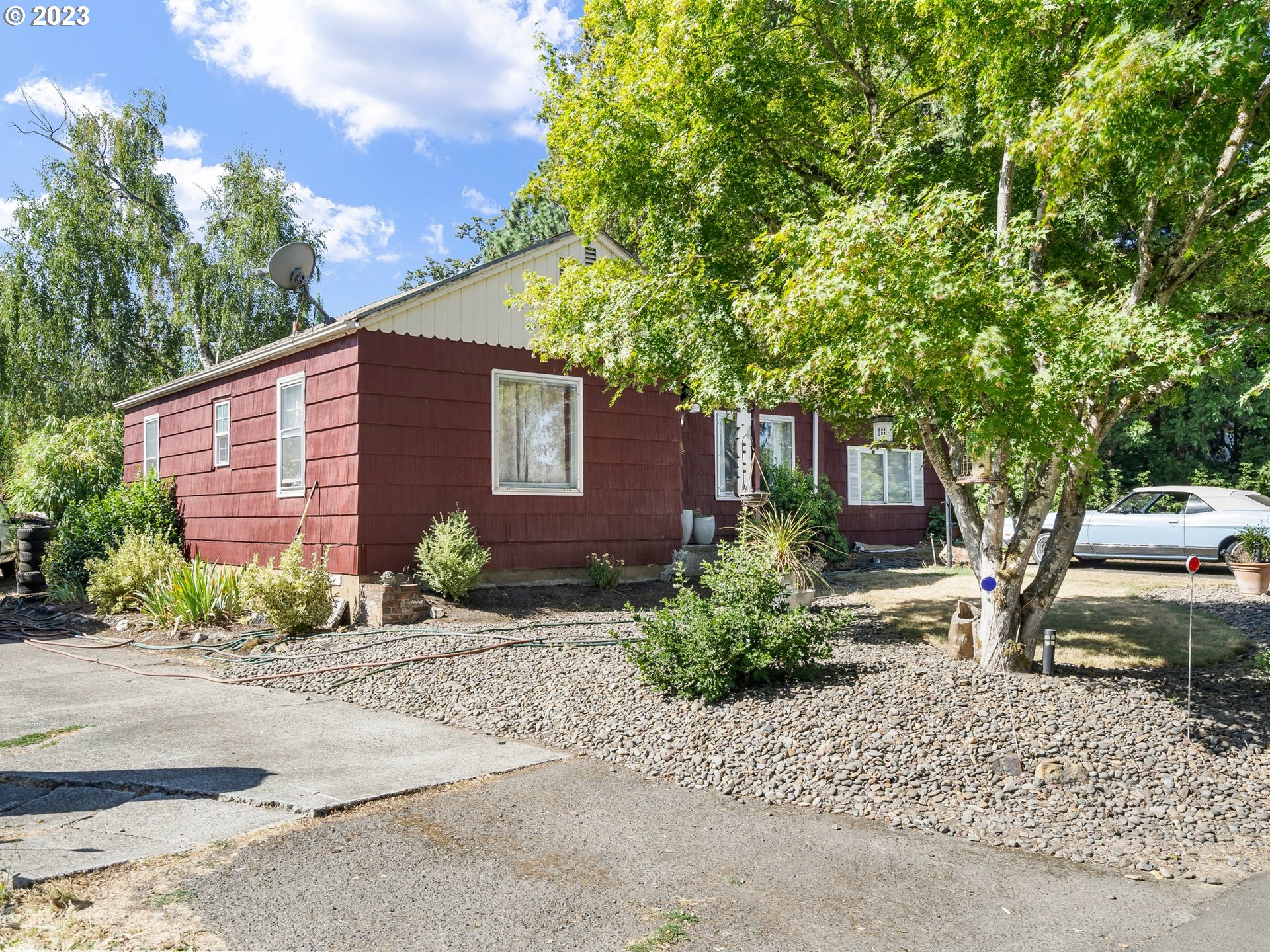 17680 Southwest Alexander Street Beaverton, OR 97003 - Photo 3 of 38 a front view of a house with garden