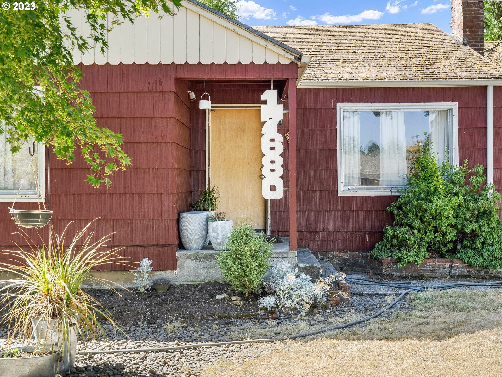 17680 Southwest Alexander Street Beaverton, OR 97003 - Photo 5 of 38 a front view of a house with garden