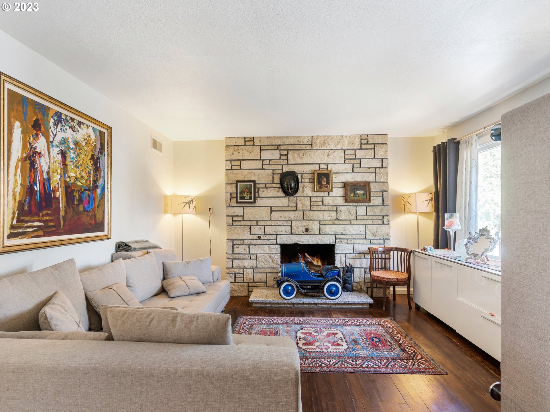 17680 Southwest Alexander Street Beaverton, OR 97003 - Photo 7 of 38 a living room with furniture and a fireplace
