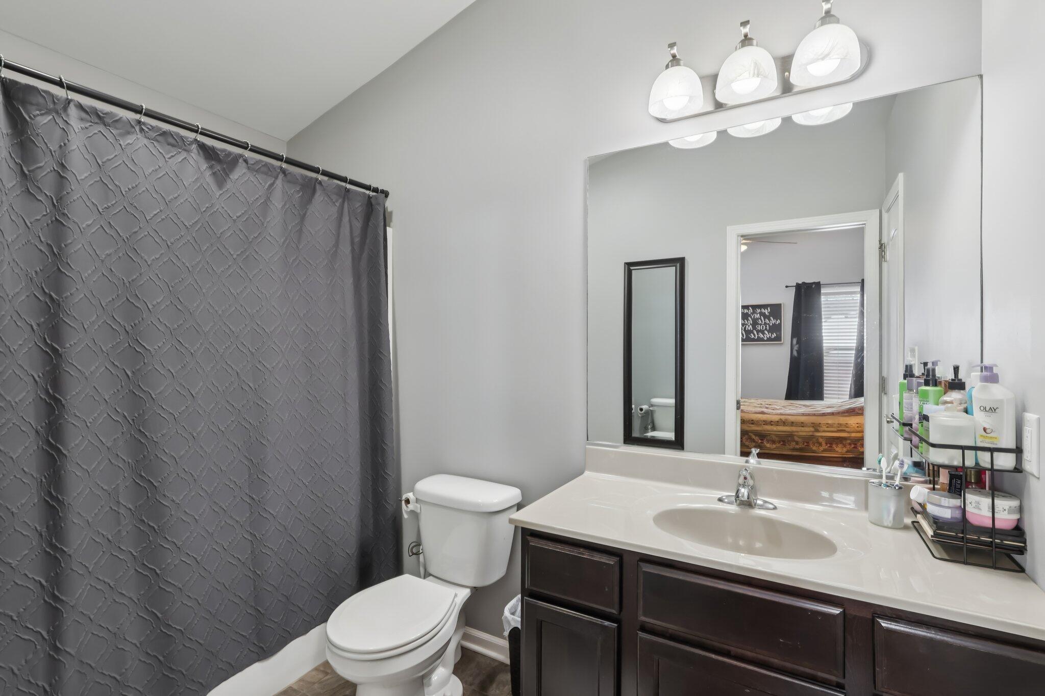 2235 Coldspring Road Crown Point, IN 46307 - Photo 26 of 51 a bathroom with a toilet a sink and a large mirror