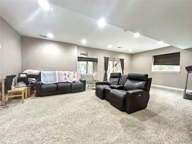 a living room with furniture window and a flat screen tv