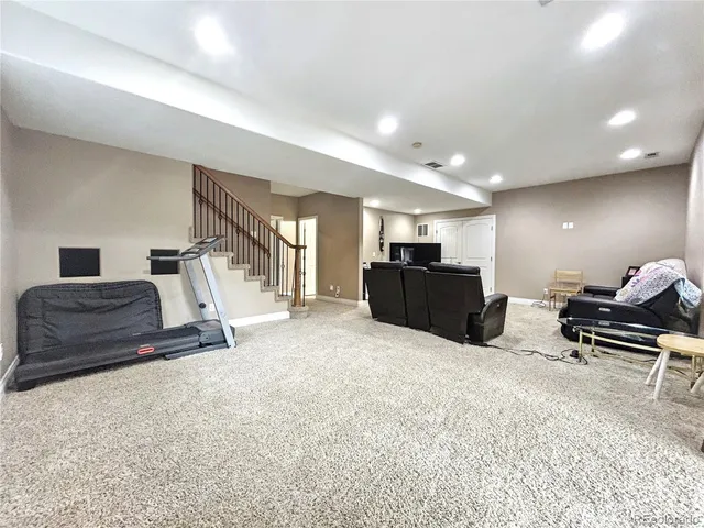 a living room with furniture and a bed