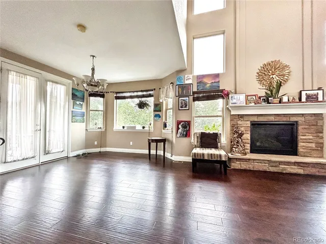 an empty room with fireplace and windows