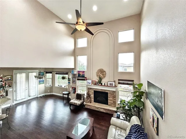 a view of a livingroom with furniture a fireplace and wooden floor