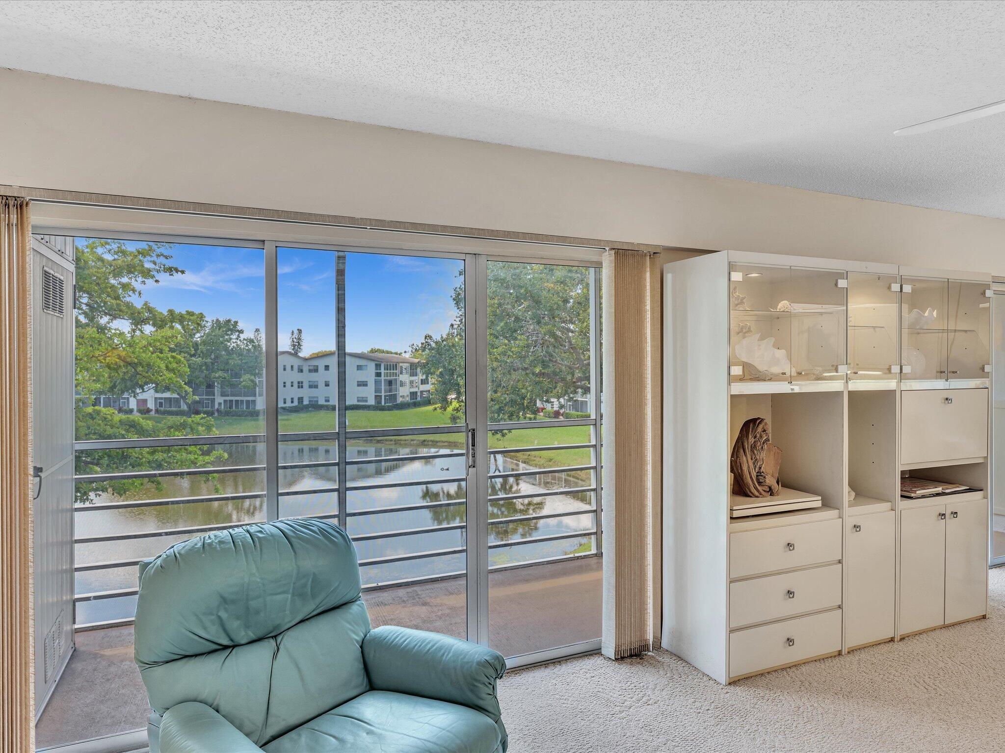 288 Fanshaw Drive, Unit G Boca Raton, FL 33434 - Photo 15 of 49 a living room with furniture and a floor to ceiling window