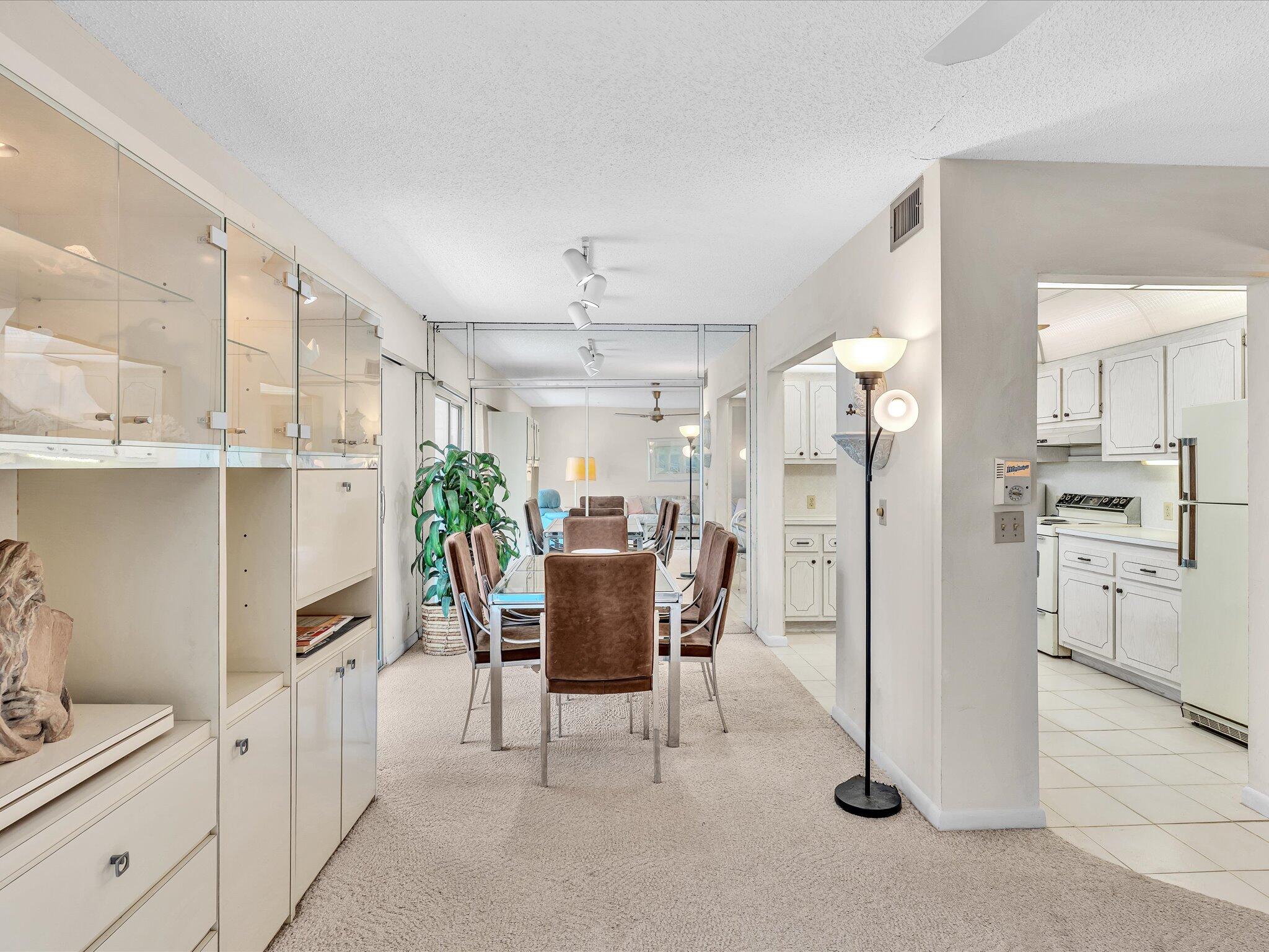 288 Fanshaw Drive, Unit G Boca Raton, FL 33434 - Photo 17 of 49 a kitchen with a refrigerator and white cabinets