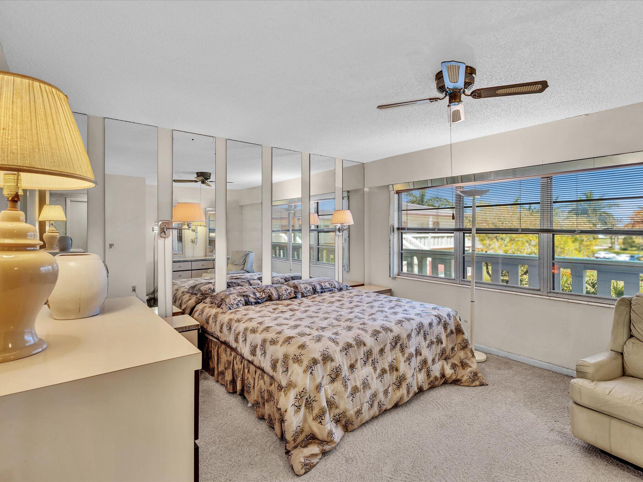 288 Fanshaw Drive, Unit G Boca Raton, FL 33434 - Photo 24 of 49 a bedroom with a bed and wooden floor