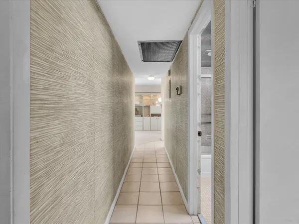 a kitchen with stainless steel appliances granite countertop a sink a stove a refrigerator cabinets and chairs