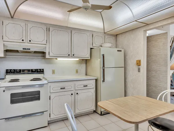 a kitchen with cabinets and white appliances