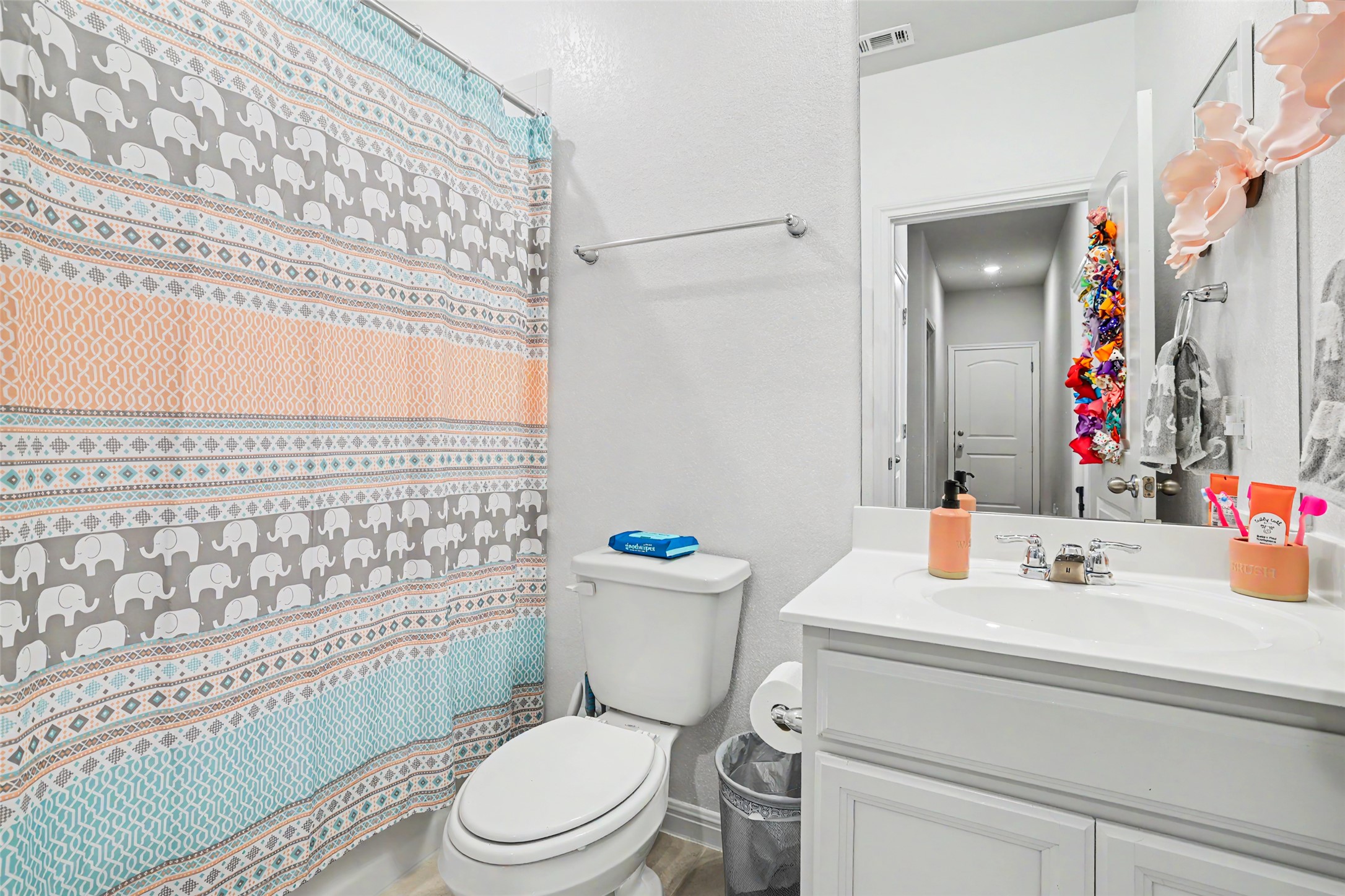 112 Rocking R Court Georgetown, TX 78633 - Photo 30 of 40 A well-appointed bathroom with a white vanity and a practical commode.
