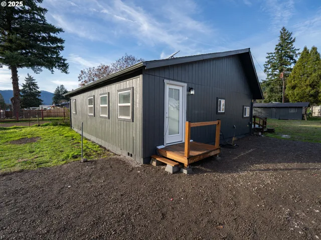 a view of a backyard with a garden and entertaining space