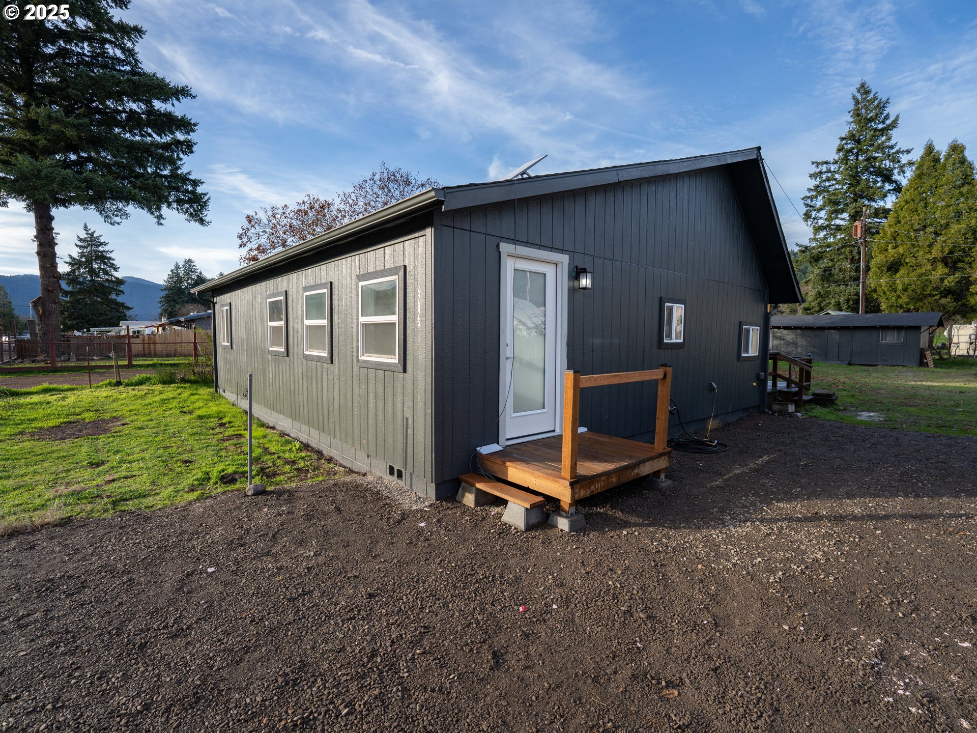 a view of a backyard with a garden and entertaining space