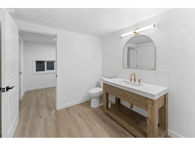 a bathroom with a sink mirror and toilet