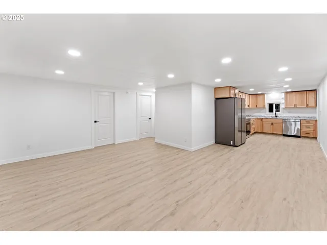 a view of a kitchen with a sink and a refrigerator