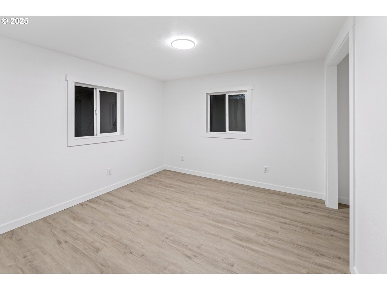 47875 Elgin Avenue Oakridge, OR 97463 - Photo 10 of 22 a view of an empty room with wooden floor and a window