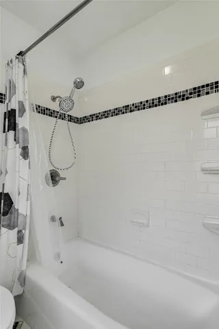 a bathroom with a shower and a bathtub
