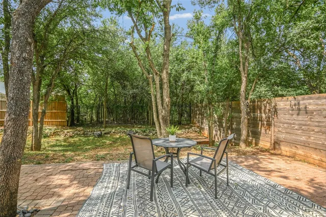 a view of a chairs and table in backyard