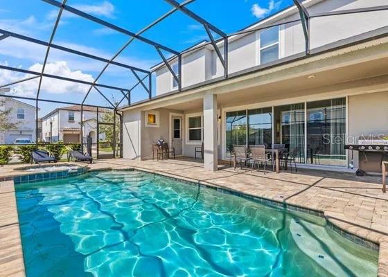 9042 Sunshine Ridge Loop Kissimmee, FL 34747 - Photo 13 of 44 a view of a swimming pool with a patio